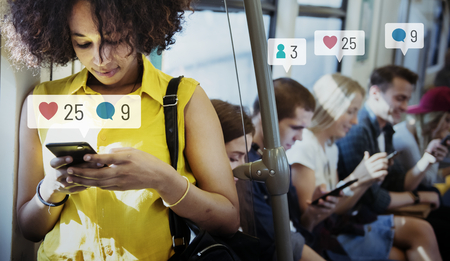 People using social media on their smartphones in the subway