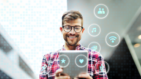 Cheerful man using a tablet
