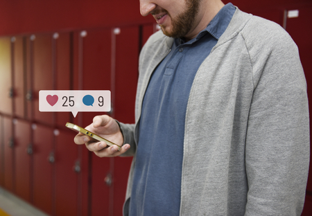 Student using social media on his smartphone