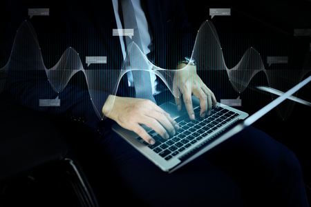 Businessman checking a financial report from his laptop