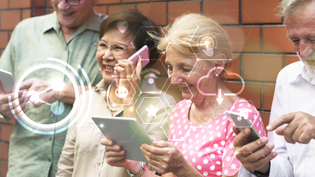 Group of diverse elderly using digital devices