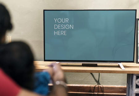Family watching TV at home