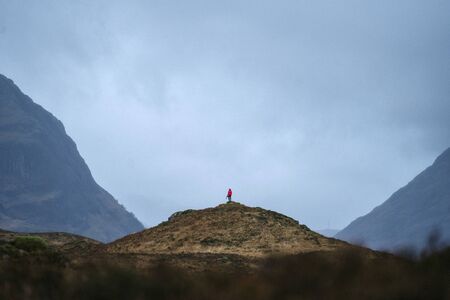 Female photographer on top of a hill at Glen Etive, Scotland