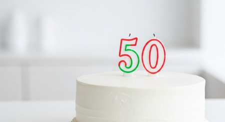 birthday cake with candles on it in front of blurred backgroundの素材