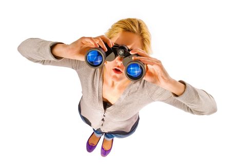close up of woman watching through binocularの写真素材