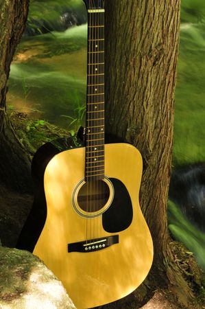 Acoustic Guitar Near Small Creek Waterfallの写真素材