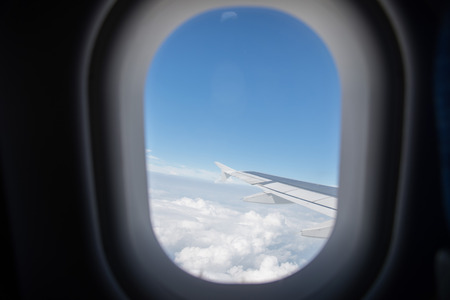 Wing of an airplane flying in the sky so beautiful.の写真素材