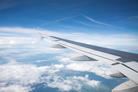 Wing of an airplane flying in the sky so beautiful.の写真素材