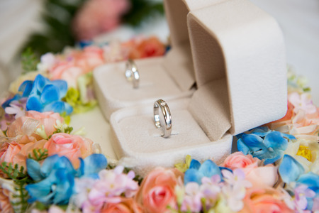 Wedding rings on wedding bouquet, close-up, on light background