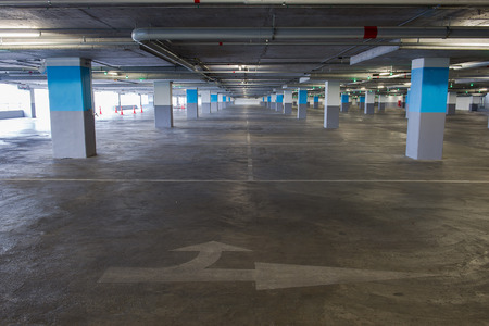 Parking garage underground interior, neon lights in dark industrial building, modern public constructionの写真素材