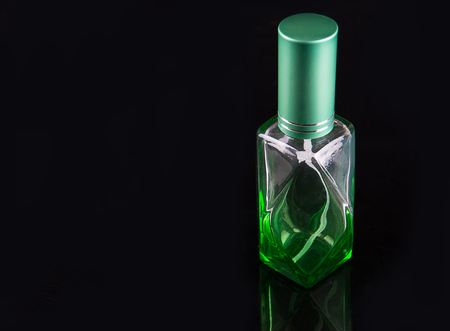 perfume spraying, isolated on black backgroundの写真素材