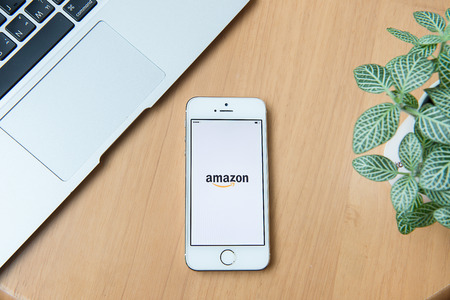 CHIANGMAI,THAILAND - JUNE 24, 2015:Amazon application on Apple iPhone 5S and Macbook display. Amazon is an American international electronic commerce companyのeditorial素材