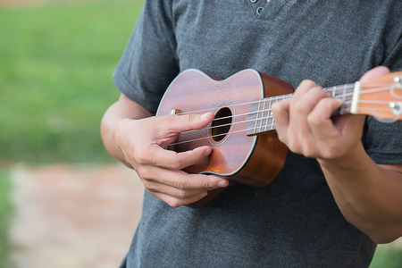 A man playing ukulele in close up view.の写真素材
