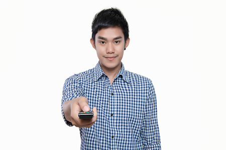 Portrait Of Young Man With Glasses Changing Channel With Tv