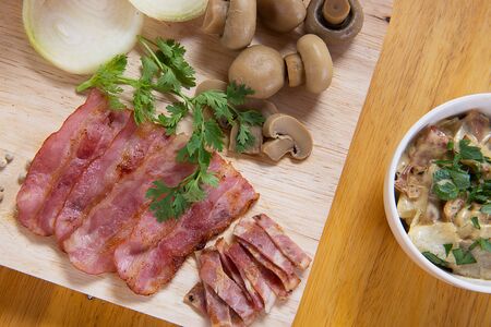Ham, mushroom carbonara on a wooden floor.の写真素材