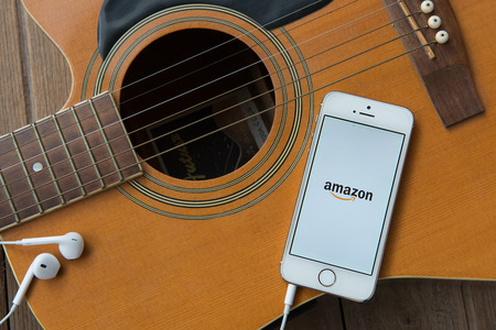 CHIANGMAI,THAILAND - JUNE 23, 2015:Amazon application on Apple iPhone 5S and Macbook display. Amazon is an American international electronic commerce companyのeditorial素材