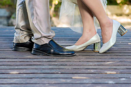 Wedding details, feet of bride and groom, wedding shoesの写真素材