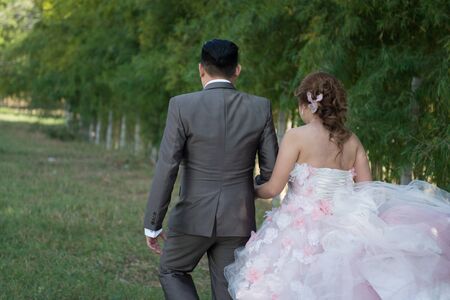 Married couple walking hand in handの写真素材