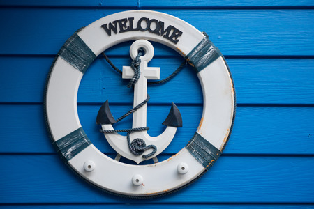 wooden anchor on wall background,little toy boat with anchorの写真素材