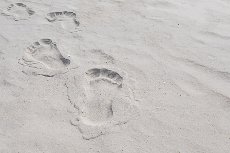 Footprints in the sand, sea, human footprints in the sand on the beach.の写真素材