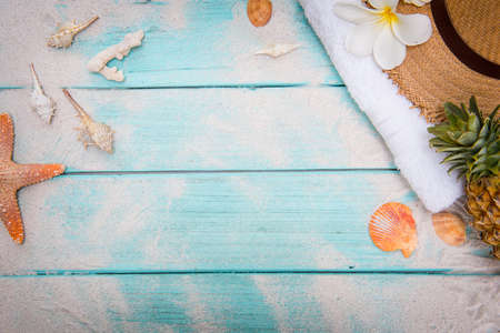 summer concept beach accessories on sand pastel wooden board.の写真素材