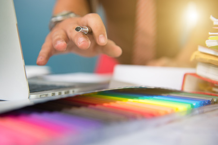 Designer hand working with laptop computer and smart phone and digital tablet on wooden desk as design conceptの写真素材