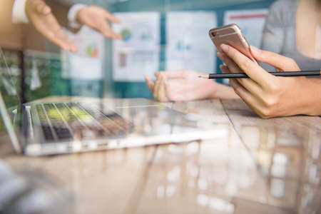 Business team meeting. Photo professional investor working new start up project. Finance task.Digital tablet docking keyboard laptop computer smart phone using, filter film effectの写真素材