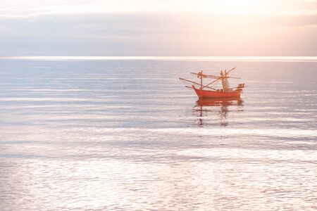 Fishing boat at sunset is fallingの写真素材