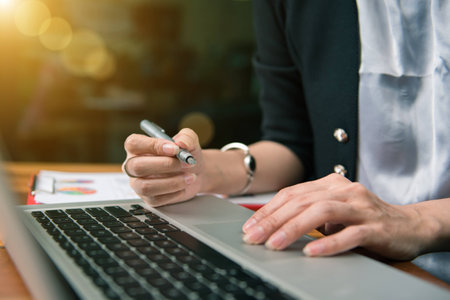 businesswoman hand working with finances about cost and calculatorの写真素材