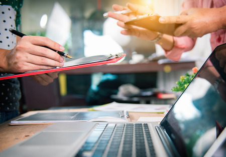 Business team meeting. Photo professional investor working new start up project. Finance task.Digital tablet docking keyboard laptop computer smart phone using, filter film effectの写真素材