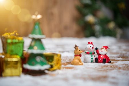 christmas teddy santa claus santa claus and snowman on the snow with christmas tree already decorated in wicker background.の写真素材