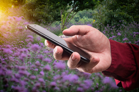 Man holding mobile smart phone in various placesの写真素材