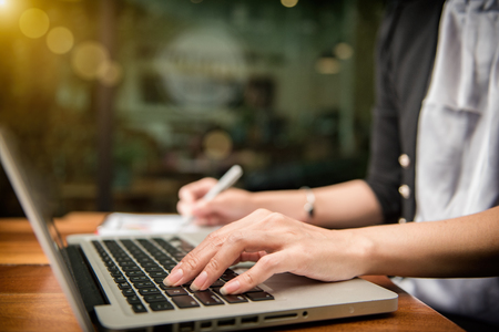 businesswoman hand working with finances about cost and calculatorの写真素材