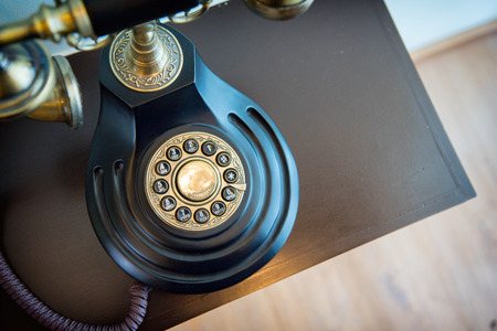 Old phone on the deskの写真素材