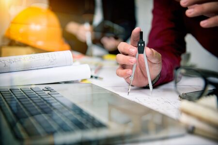 Cooperation Corporate Achievement Planning Teamwork ConceptClose-up Of Person's engineer Hand Drawing Plan On Blue Print with architect equipment.の写真素材