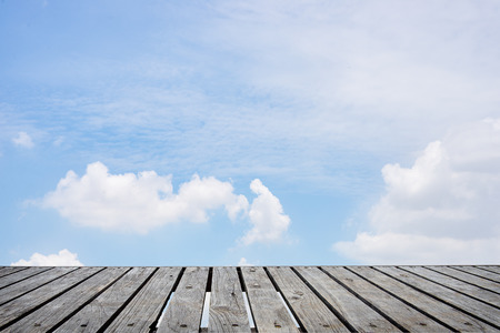 Wood table top on blue sky background - used for display your productsの写真素材
