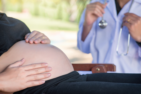 Doctor examining a pregnant womanの写真素材