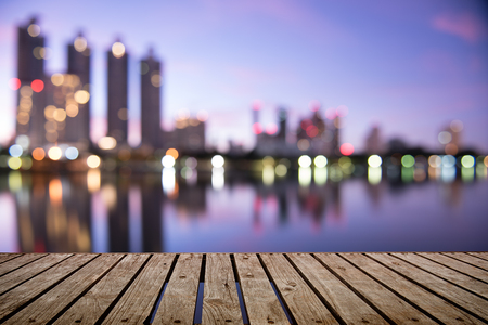Twilight blurred bokeh city office building with water reflection, abstract backgroundの写真素材