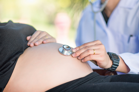 Doctor examining a pregnant womanの写真素材