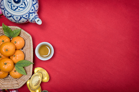 Top view accessories Chinese new year festival,leaf,wood basket,red packet,plum blossom,teapot on red background.の写真素材