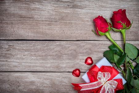Valentines day background with rose and ribbon on wooden.の写真素材