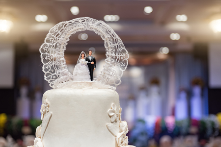 Close-up of figurine couple on wedding cake at wedding with bokehの写真素材