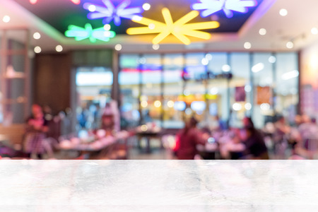 White marble table top on blur coffee shop window background. For product or foods montage.の写真素材