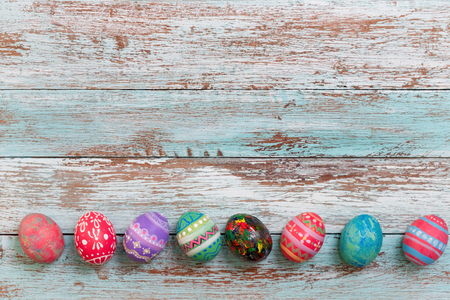 Colorful Easter egg side border against a rustic wood Vintage pastel backgroundの写真素材