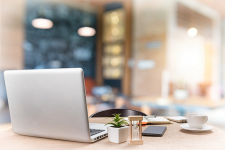 Workplace with notebook laptop Comfortable work table in coffee shopの写真素材
