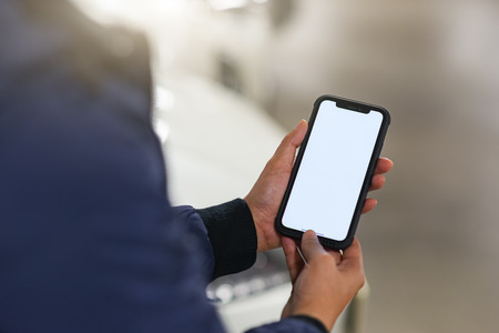 Hand is holding showing smartphone with blank mock up screen,This can be used to montage the mobile application.の写真素材