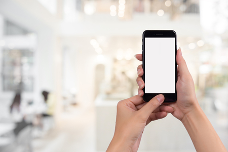 Young woman holding smart phone with blurred background. For Graphic display montage.with copy space.の写真素材