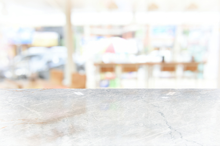 White marble table top on blur coffee shop window background. For product or foods montage.の写真素材