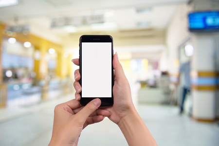 Cropped shot view of woman's hands holding smart phone with blank copy space screen for your text message or information content.の写真素材