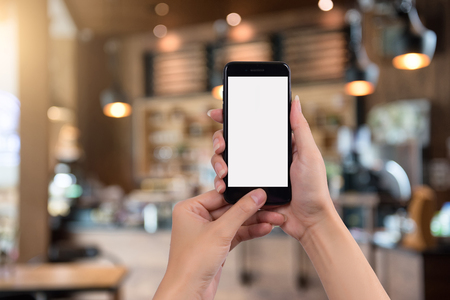 Cropped shot view of woman's hands holding smart phone with blank copy space screen for your text message or information content.の写真素材